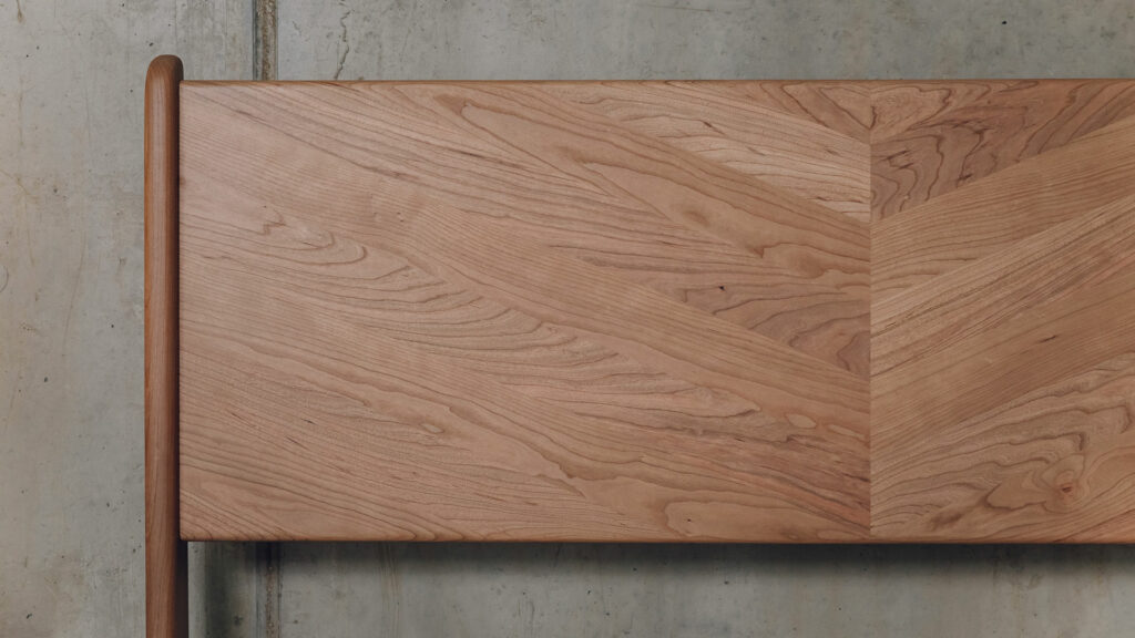 a close up view of the Hoxton bed headboard made from cherry wood