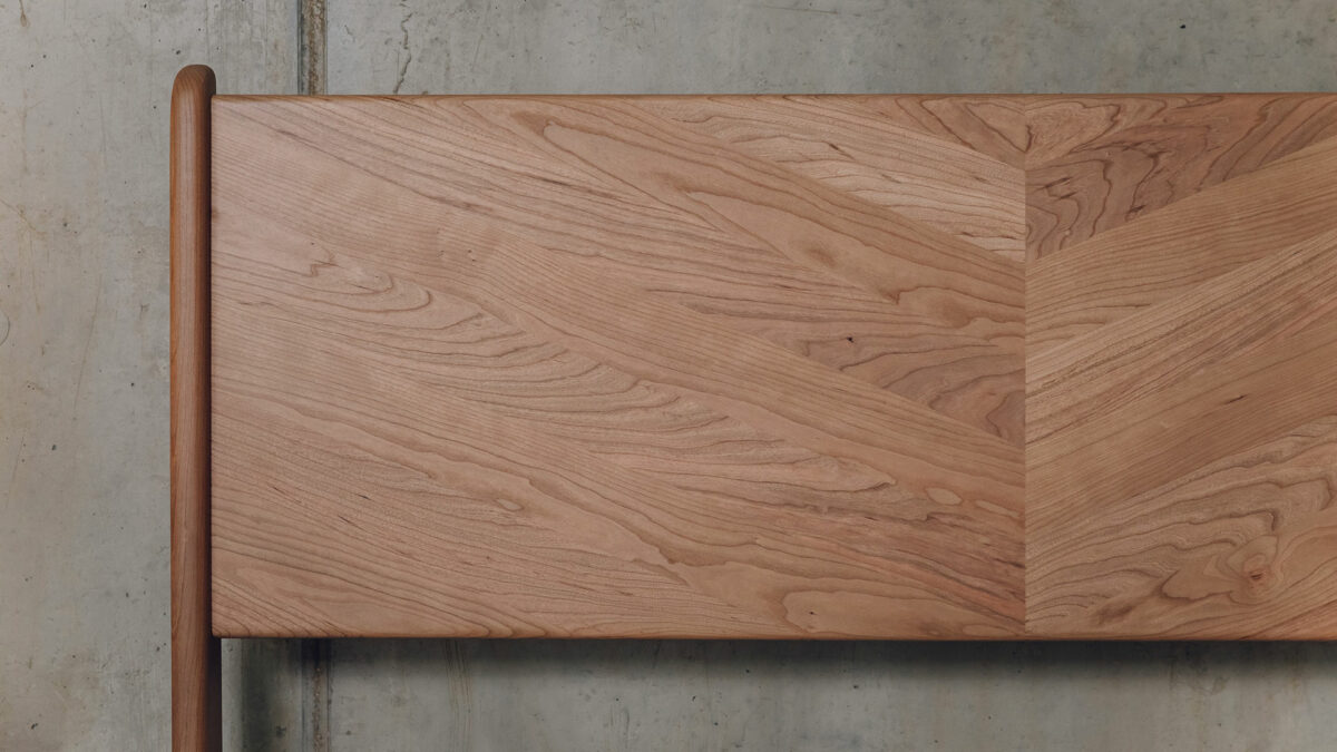 a close up view of the Hoxton bed headboard made from cherry wood