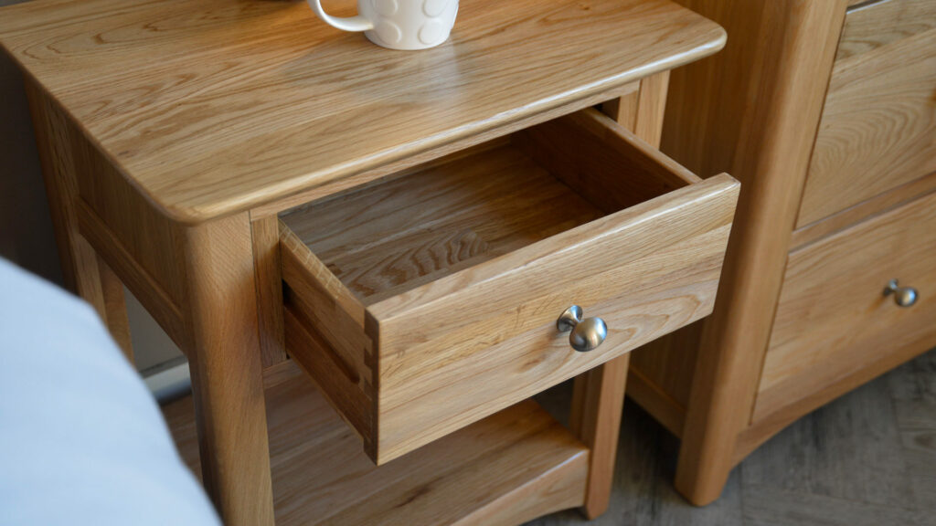 traditional style oak bedside table with drawer and open shelf drawer shown open