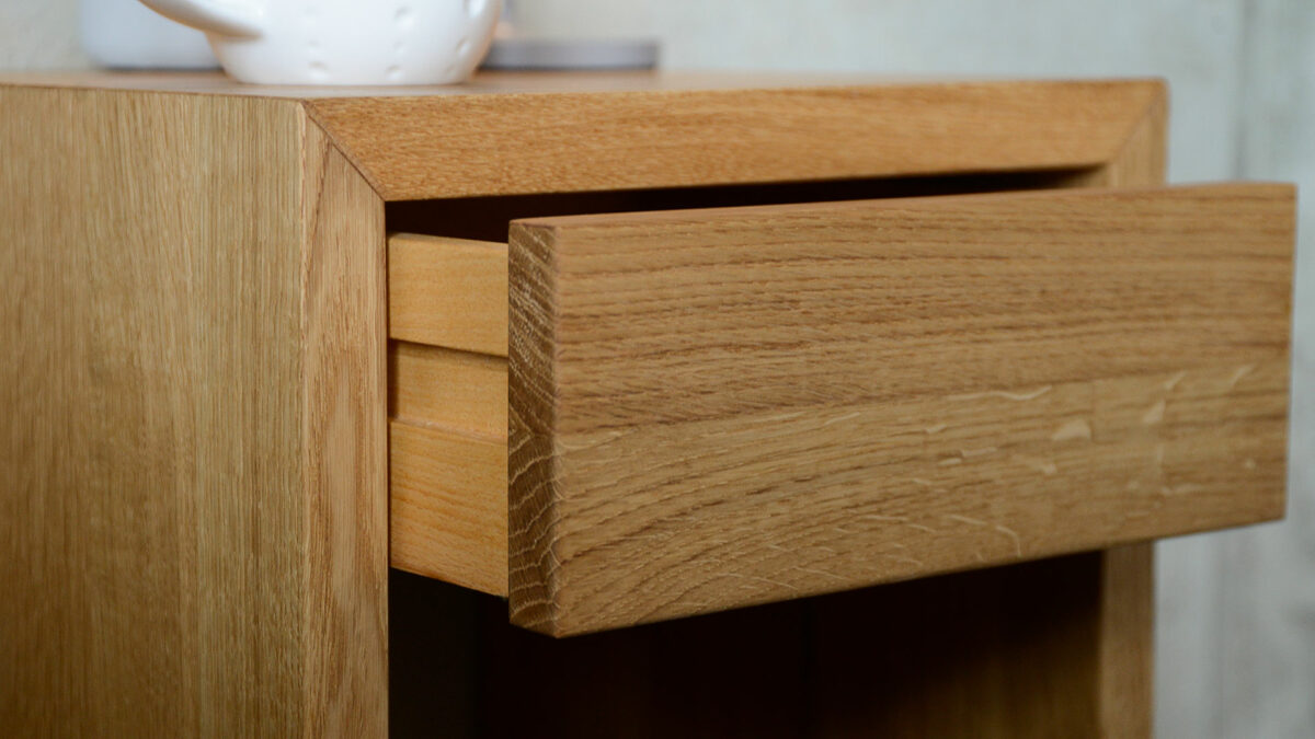 detail view of the wall mounted oak bedside table with one drawer shown open