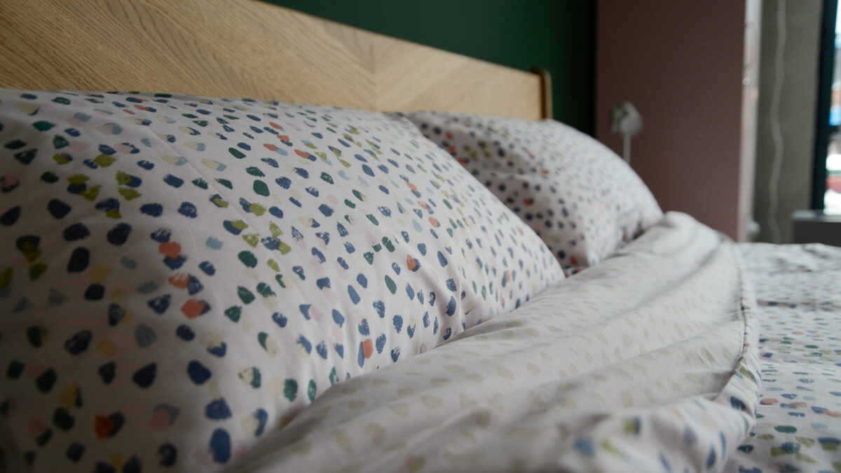 reversible cotton blend duvet cover set with pastel colours paint brush dots pattern, a close-up of the pillow