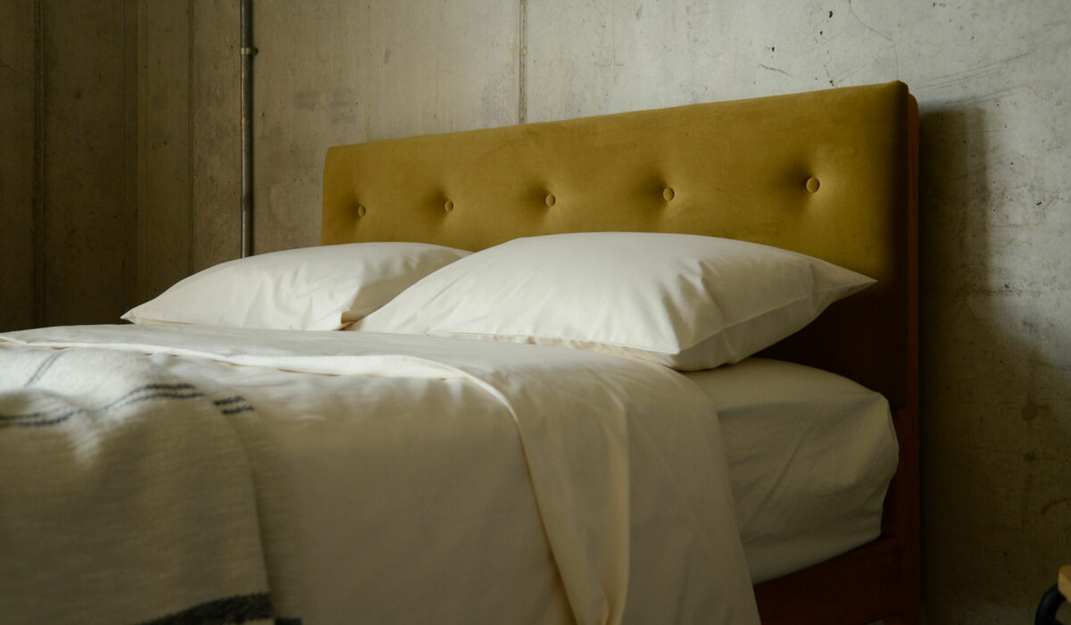 eco velvet upholstered headboard with organic cotton bedding