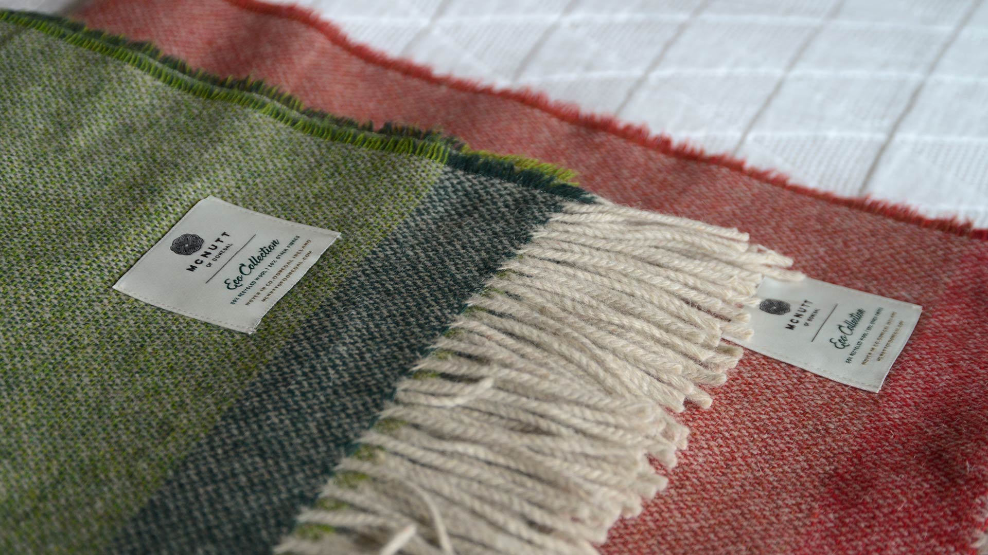 Eco collection wool throws woven from recycled wool and available in green and red