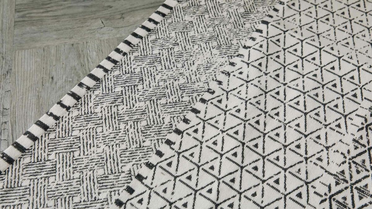edge of ivory and black rug