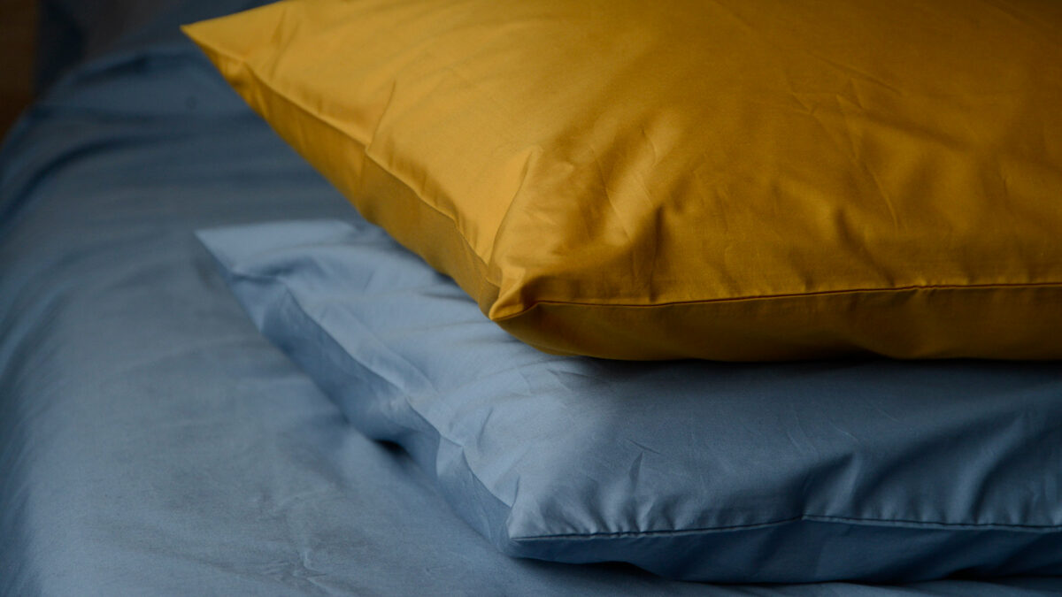 Egyptian cotton bedding available in ochre and storm blue shown together