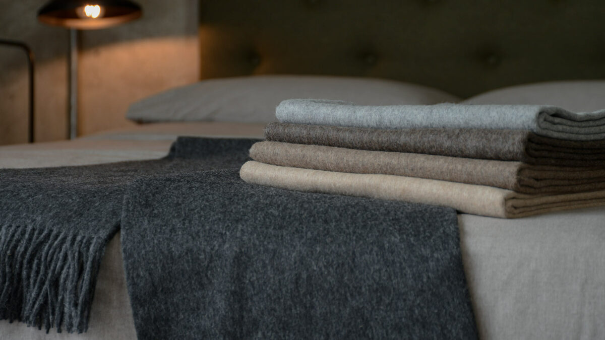 luxury recycled wool throws in a choice of neutral colours