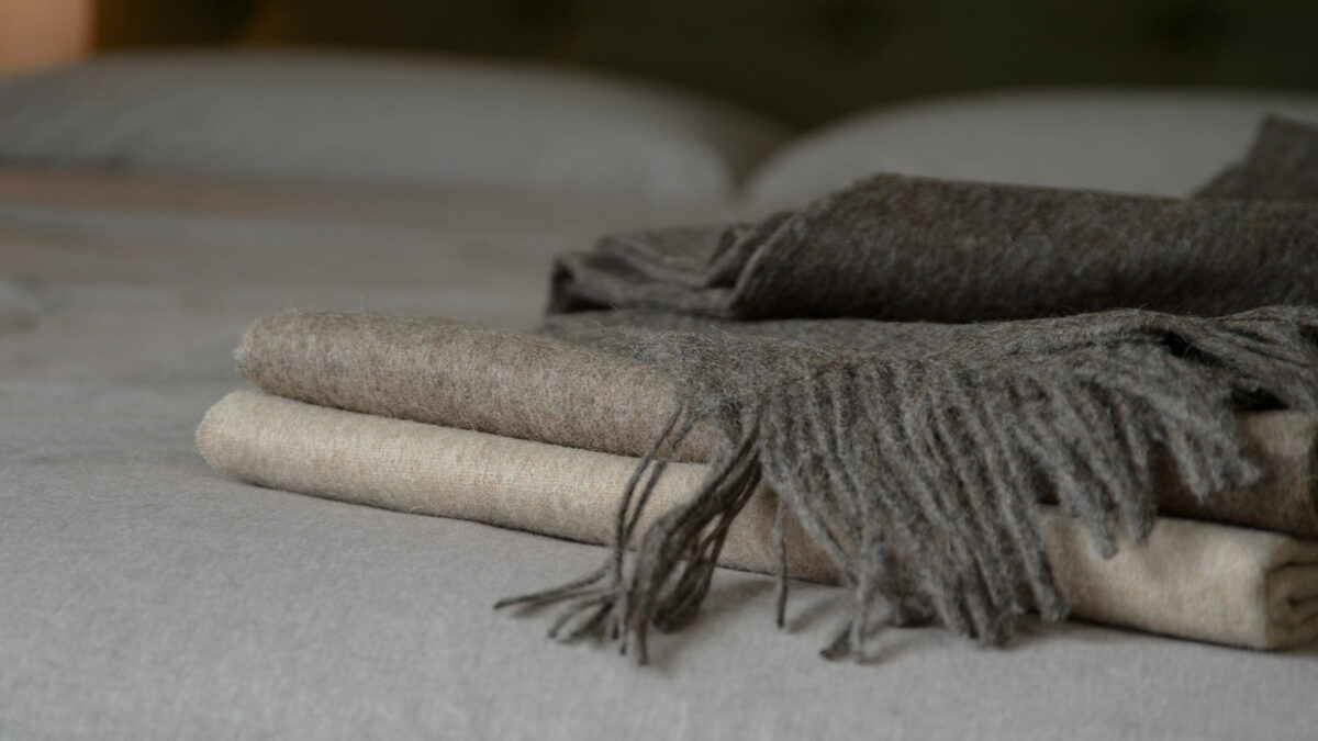 soft recycled wool fringed throws in a choice of brown marl colours