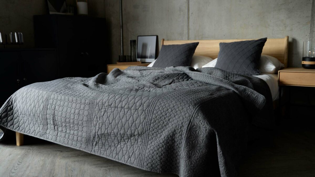 embroiderd patterned bedspread in dark grey