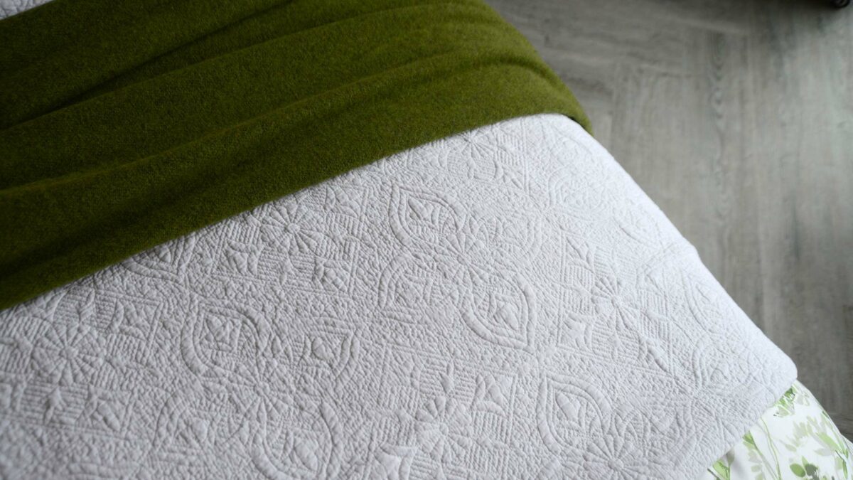 classic white embroidered and lightly quilted cotton bedspread