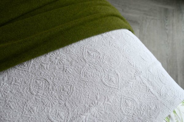 classic white embroidered and lightly quilted cotton bedspread