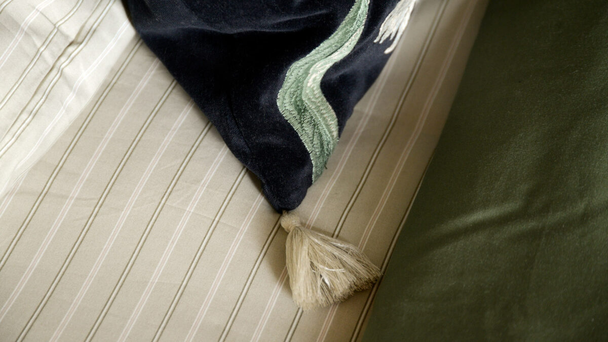 embroidered black velvet cushion cream tassle detail
