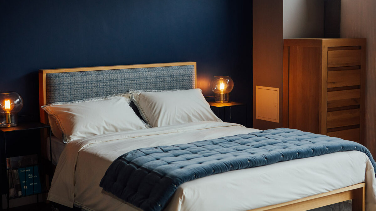 Blue patterened wool headboard on our wooden Shetland bed in Oak