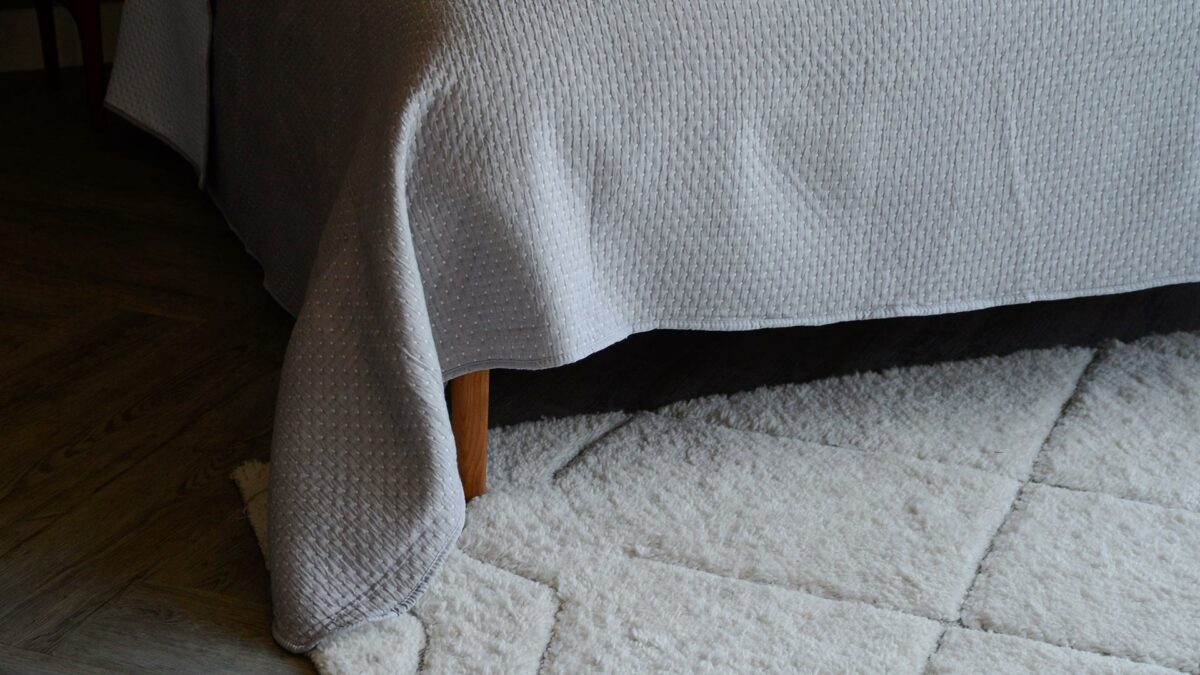 reversible stitched polka dot quilted bedspread in grey and white a detail view