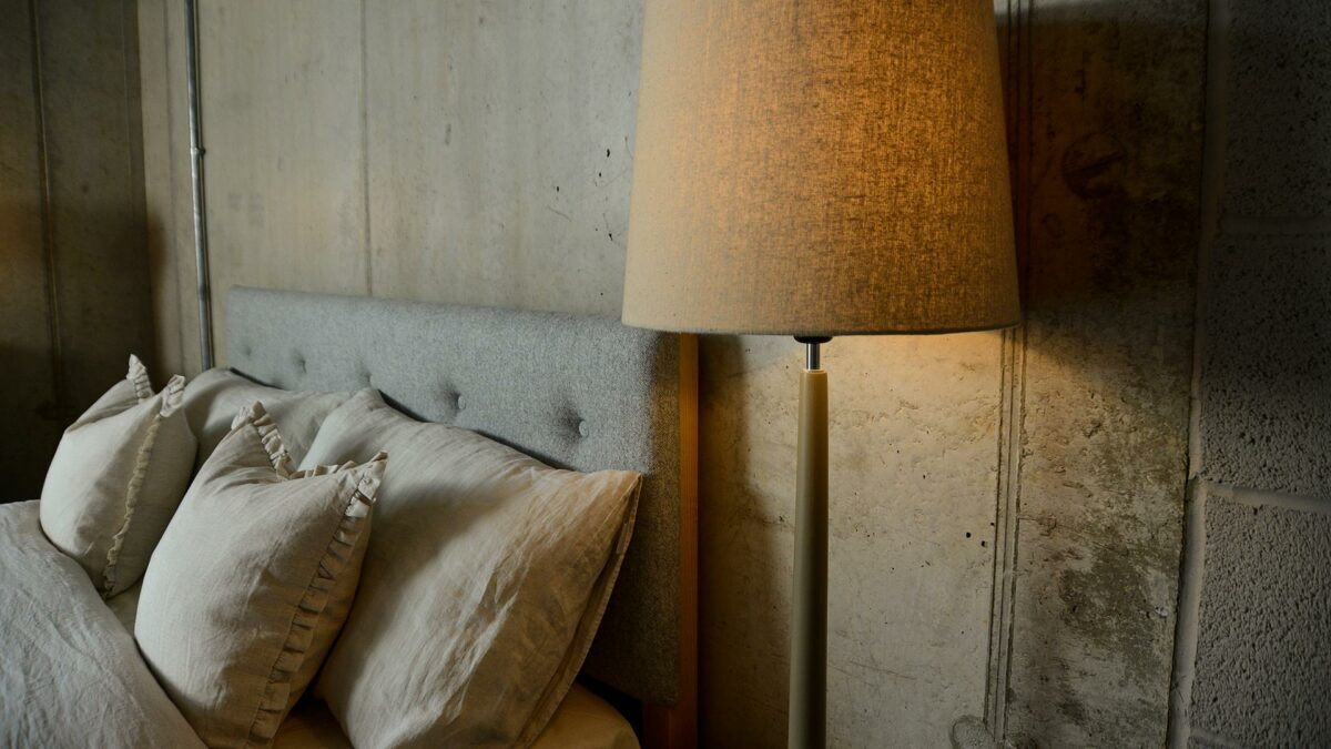 a painted wooden lamp base with linen colour shade used as a bedside light