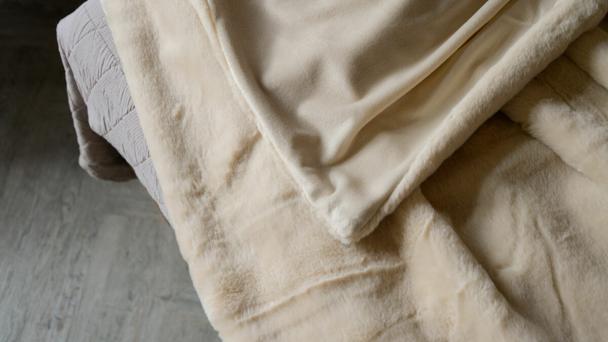 faux fur bedspread in nude colour showing velveteen reverse