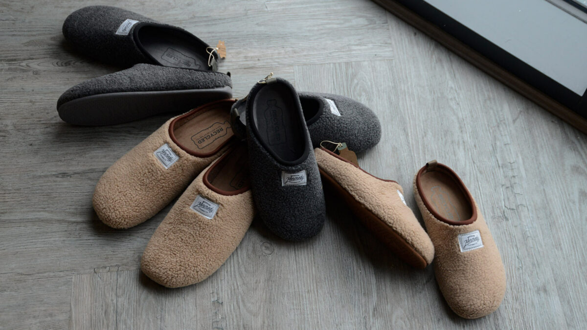 dark grey and beige sheepskin look slippers with soles sustainably made from recycled bottles