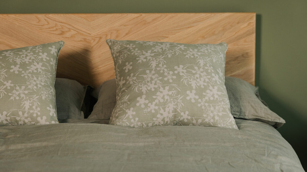 olive green square cushions with a beige floral print