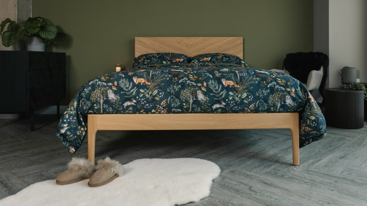 Dark green duvet cover and pillowcase set with a nature print of foxes, plants, and owls