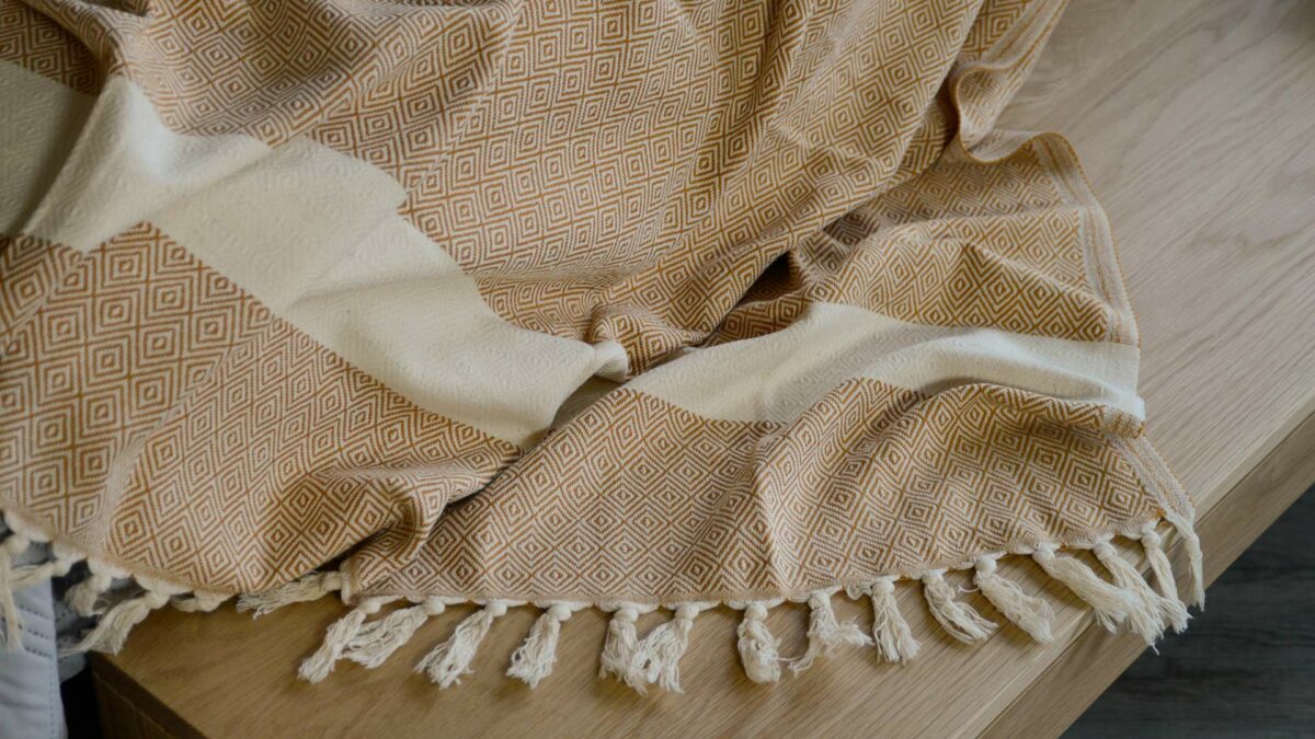 soft woven cotton blanket in cream and orange