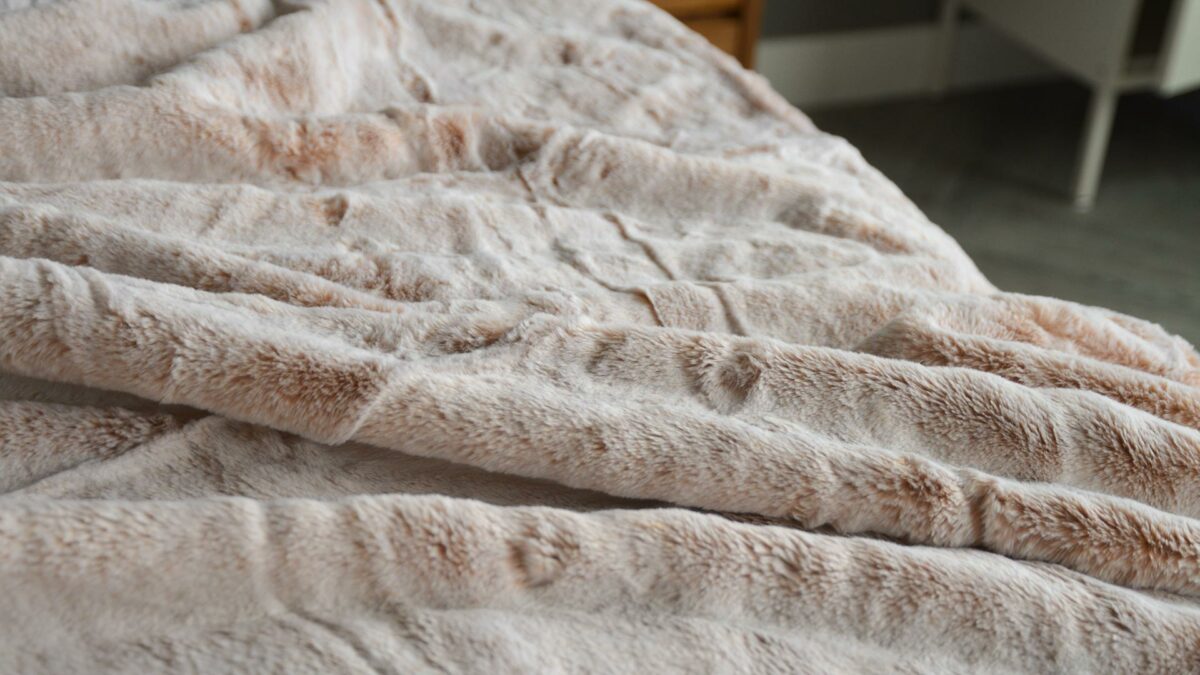 A closer view of the soft and cosy frosted pink faux fur throw