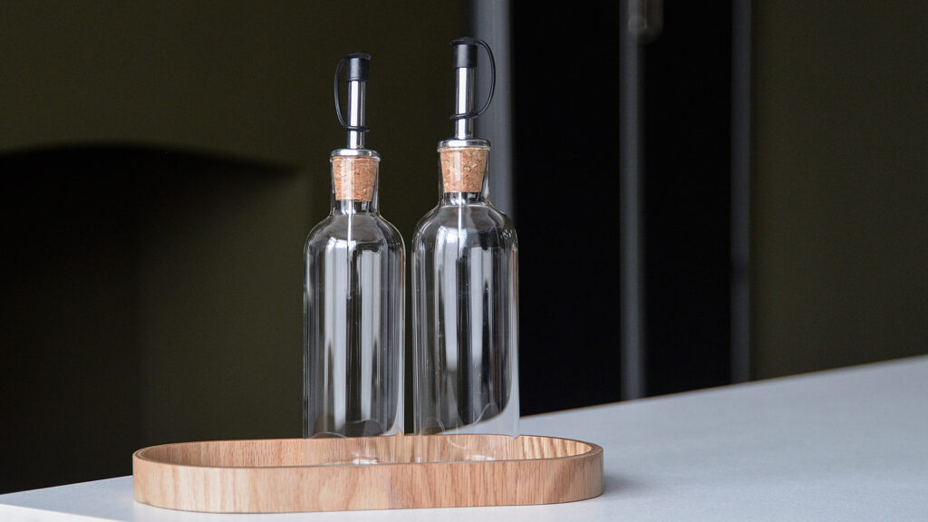 glass oil and vinegar jars with oak tray