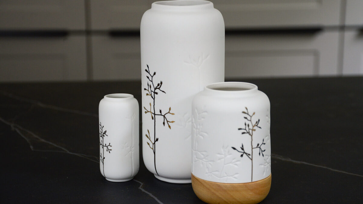 white porcelain vases with gold sprig motif and with matching candle lantern with wooden base