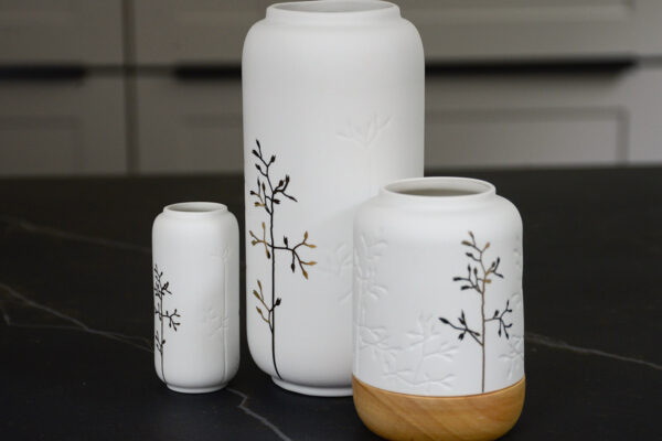 white porcelain vases with gold sprig motif and with matching candle lantern with wooden base