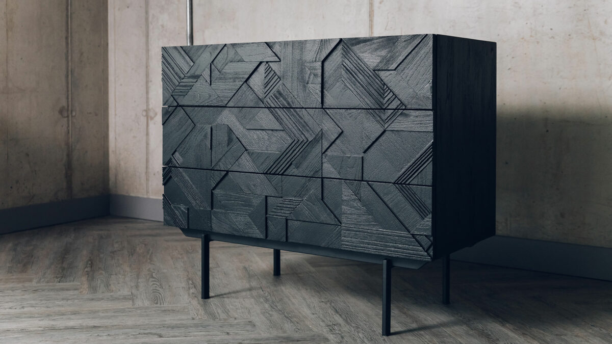 3 drawer wooden storage chest with a carved graphic pattern and black finish