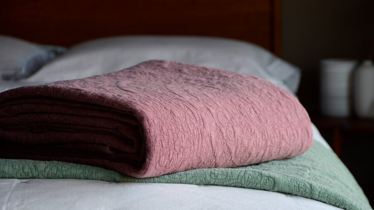 stonewash effect stitched and quilted bedspreads in wine red and sage green