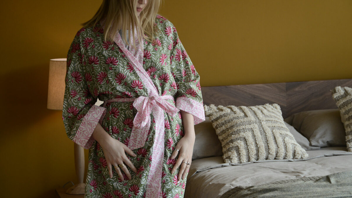 block print light cotton robe in vibrant pinks and greens shown on a model