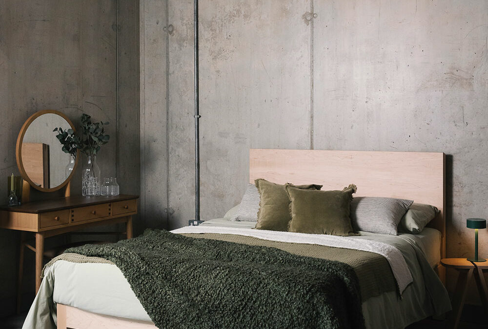 green bedding on modern maple bed portrait