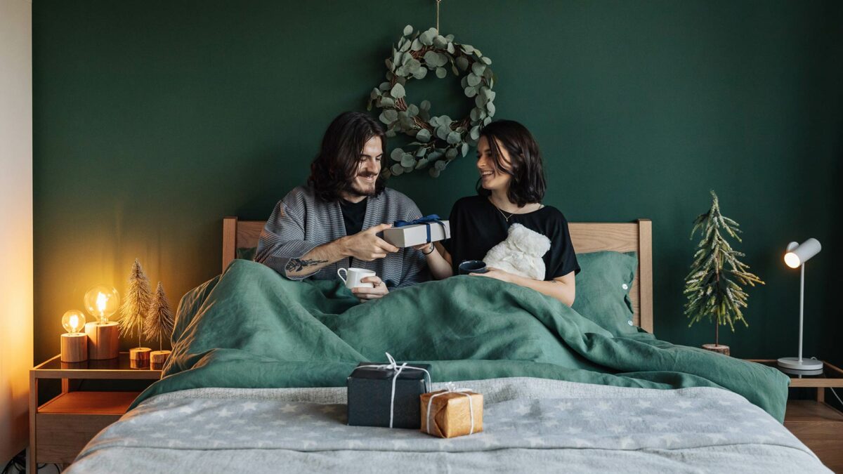 Christmas morning with green linen bedding and eucalyptus wreath