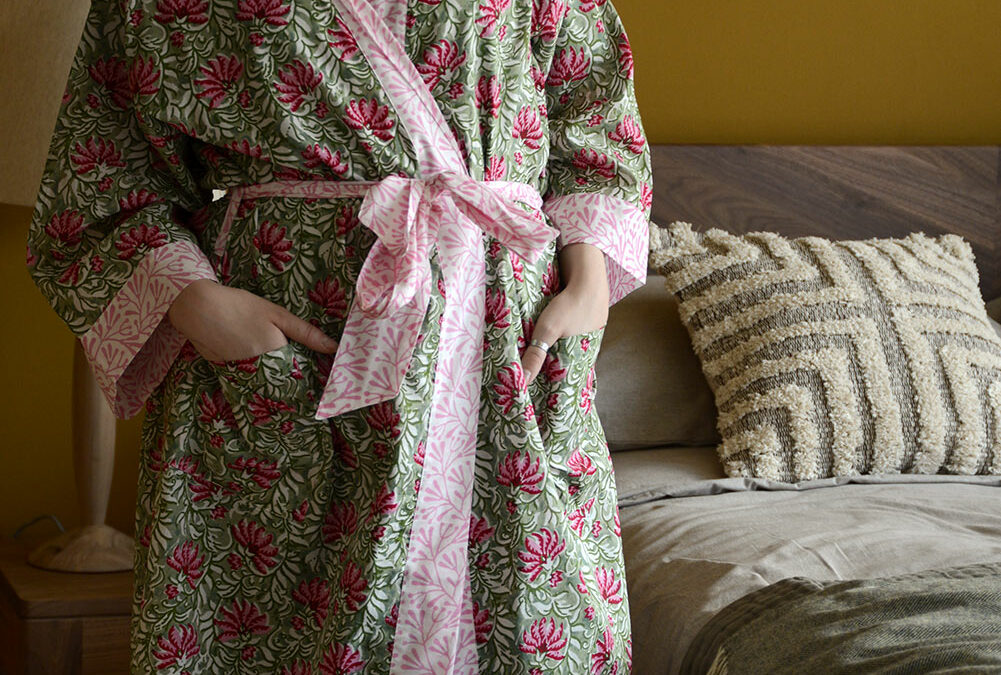 block printed light cotton robe in vibrant pinks and greens shown on a model