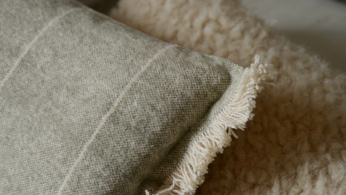 a closer look at our soft touch rectangular cushions in olive green and cream