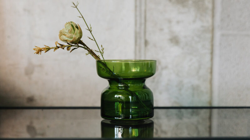 green glass candle or tea light holder, or small vase