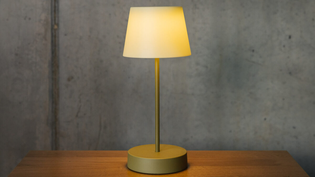 rechargeable lamp with an olive green base and a green shade and shown lit