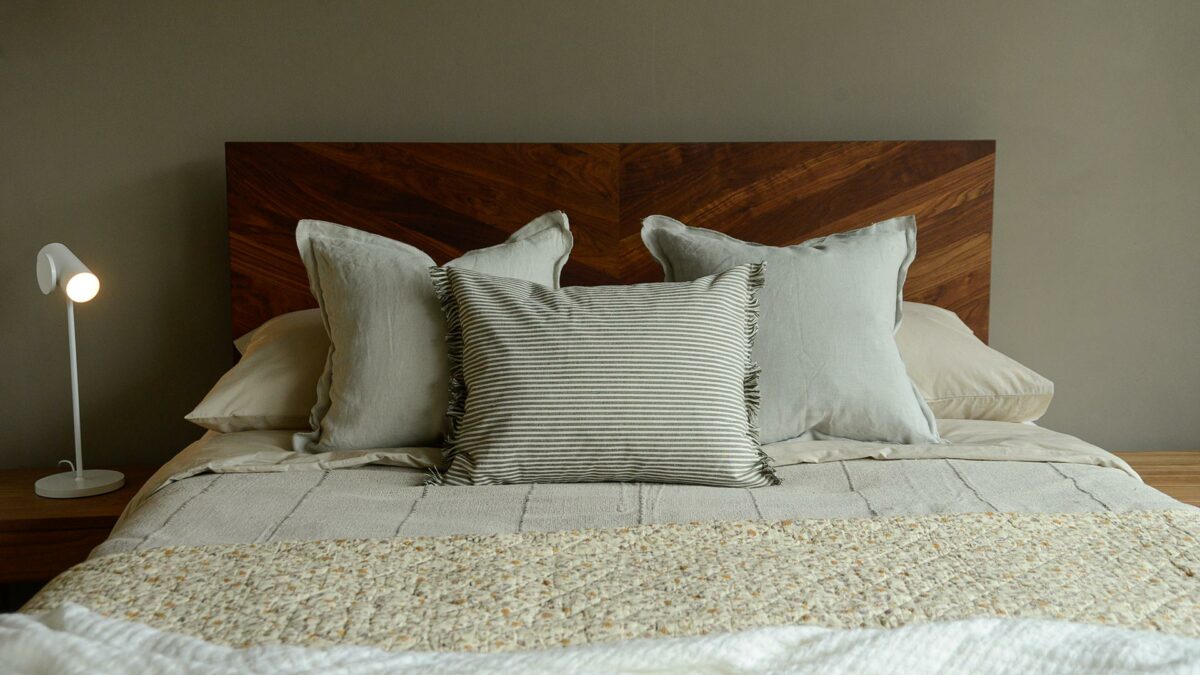 olive green and white striped cotton cushions with tassel edging