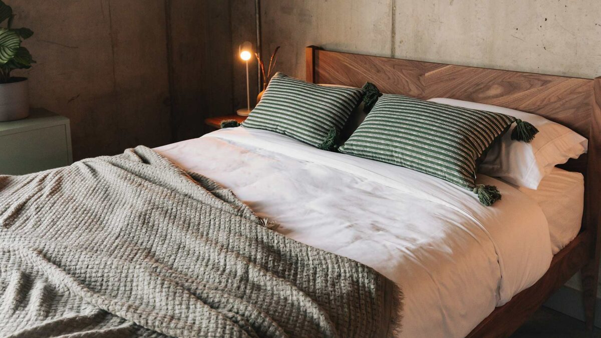 green striped cushions and textured sage throw on dalston