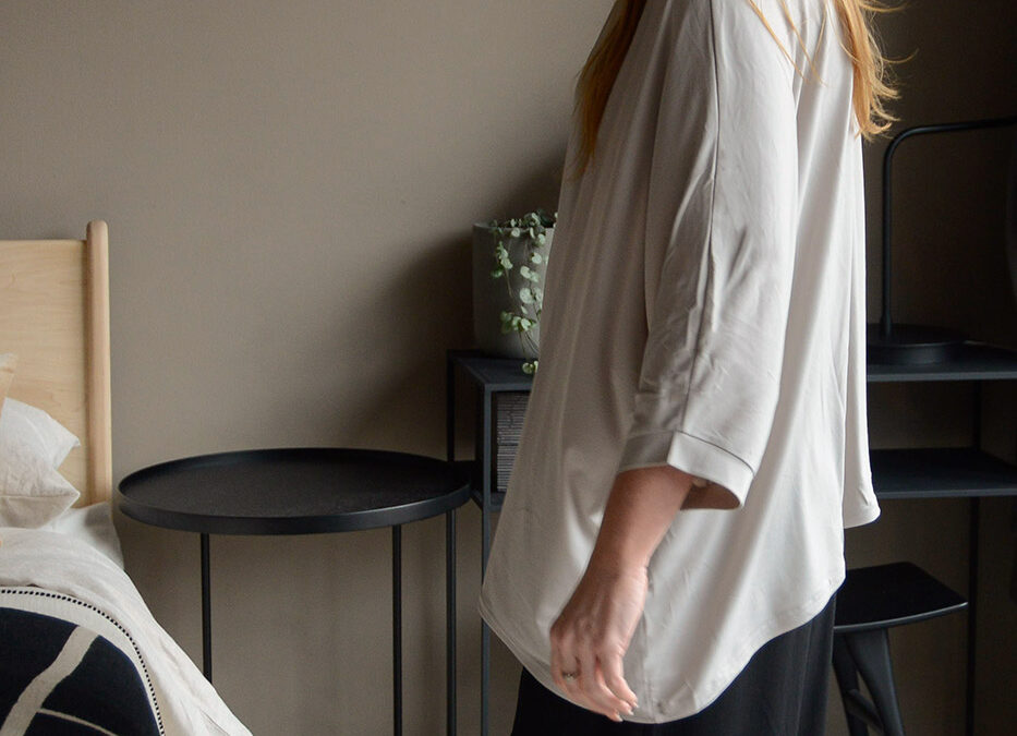 greige top and black trousers