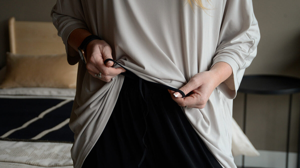 greige top with black trousers