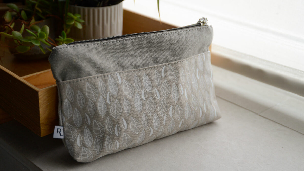 greige washbag with leaf print