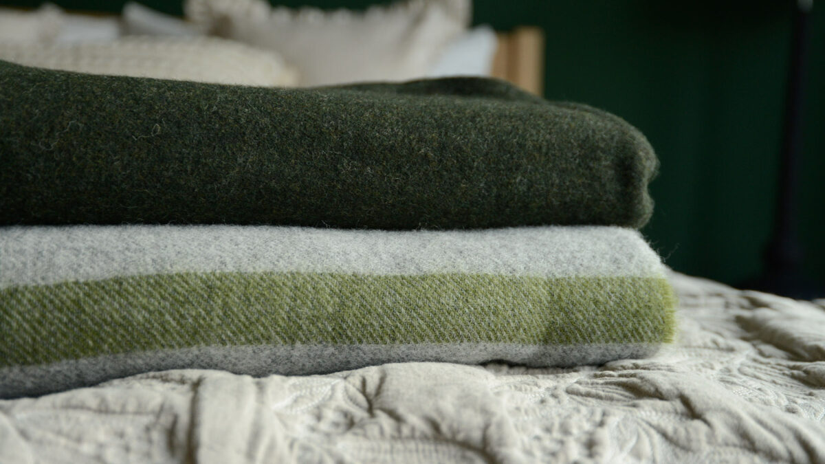 Pure wool throws in 2 colour ways and shown folded and stacked