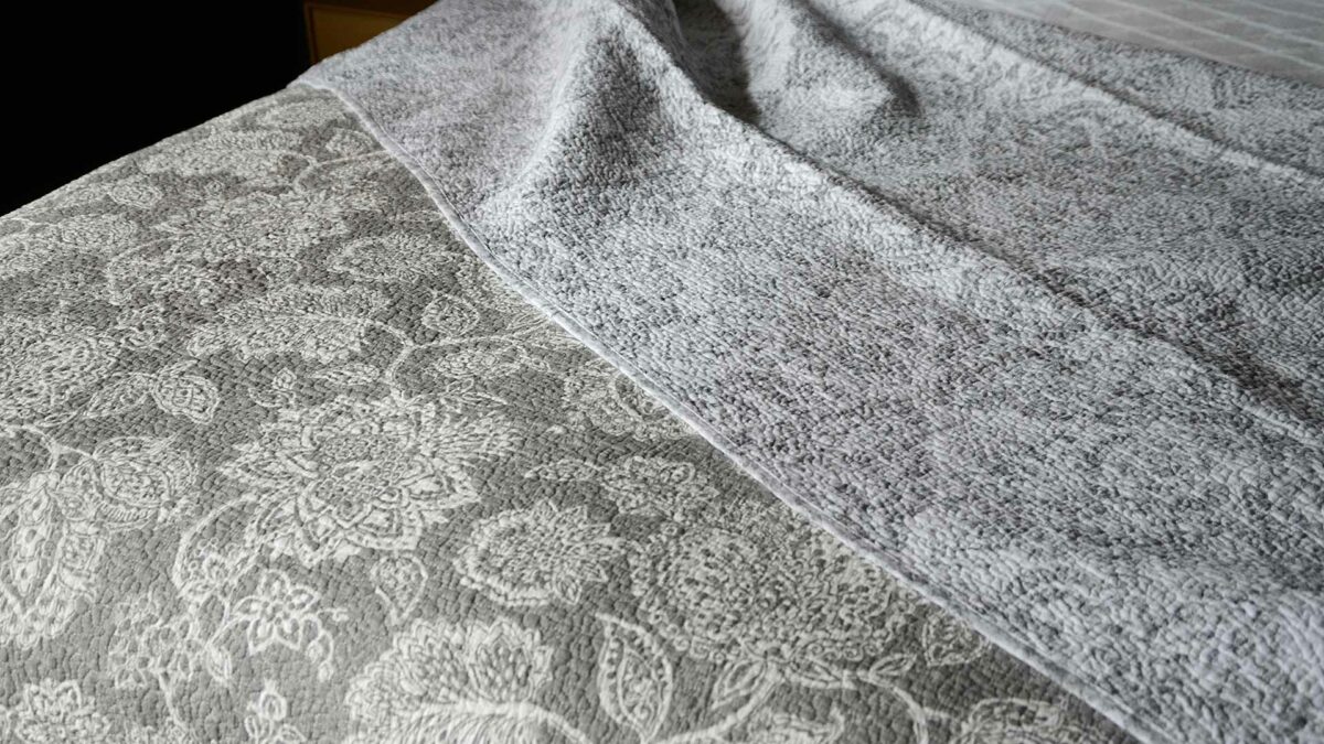 grey and white floral print reversible quilted bedspread