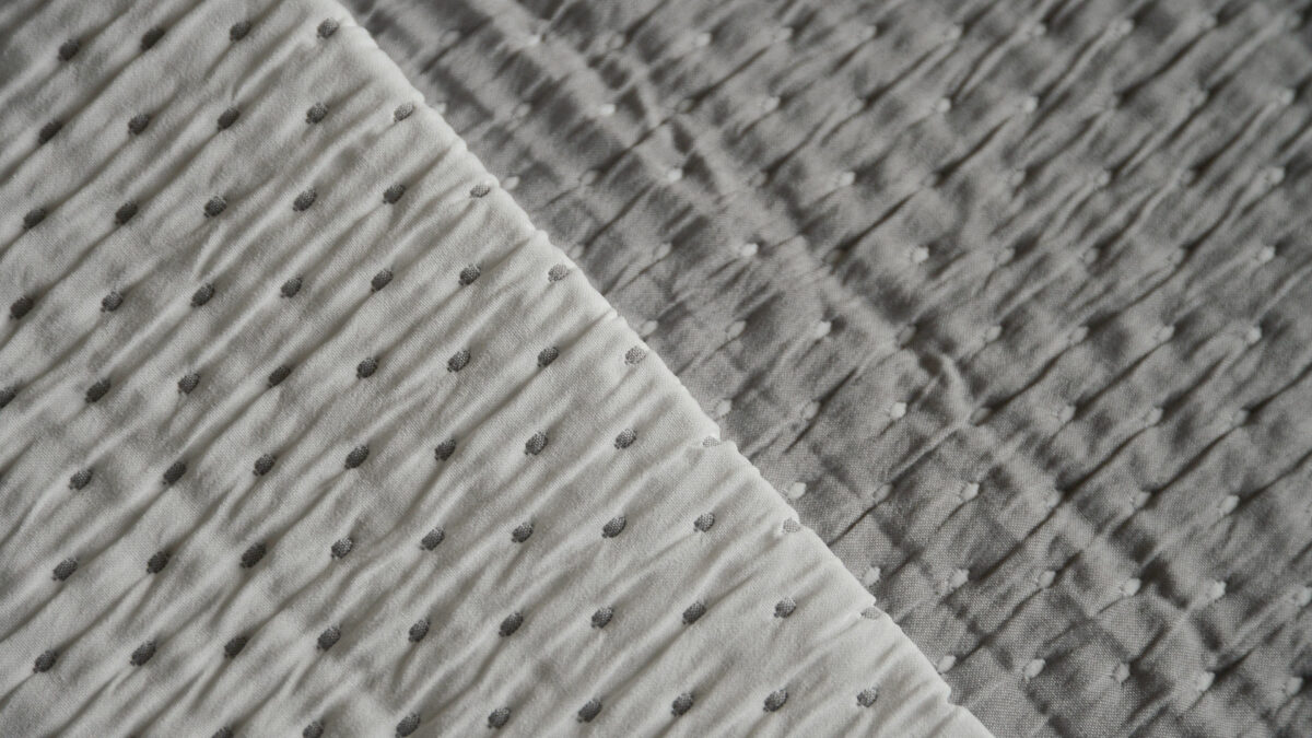 grey and white reversible embroidered bedspread