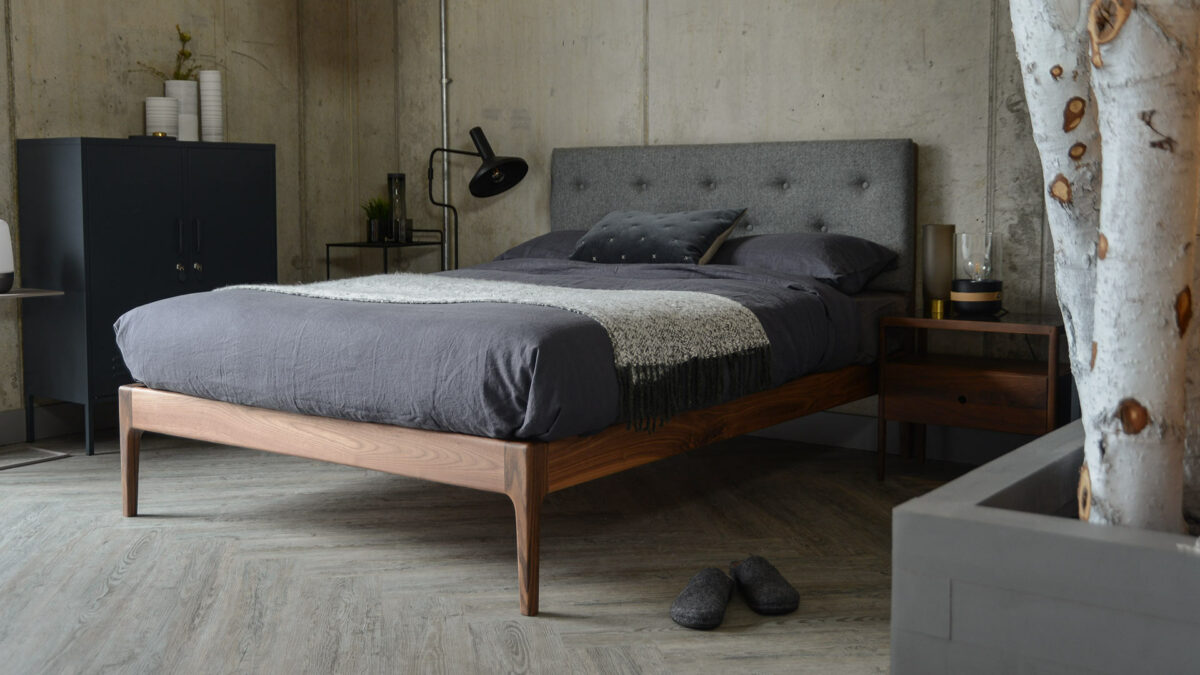 The Bloomsbury classic wooden bed with a solid walnut frame and buttoned upholstered headboard