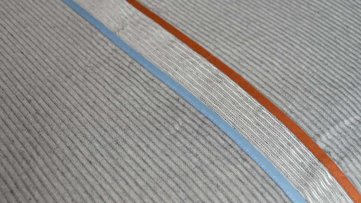 grey bedspread with ridge pattern detail