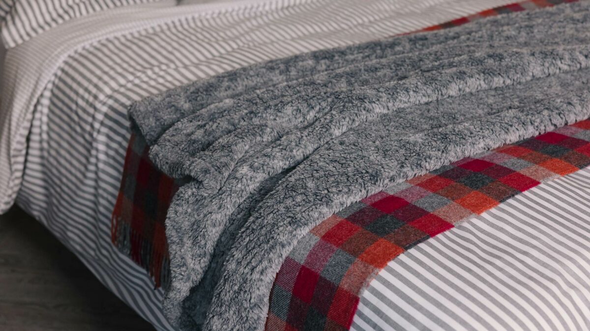 grey fleece throw with red and grey check blanket