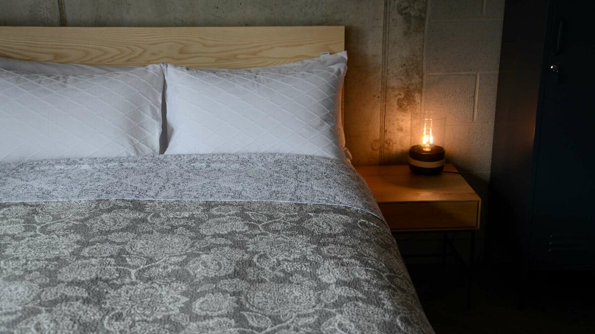 classic quilted bedspread with a grey and white floral pattern