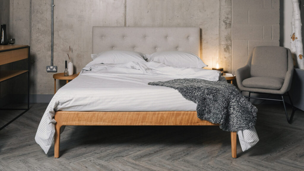grey sheepskin on striped grey bedding with Bloomsbury bed