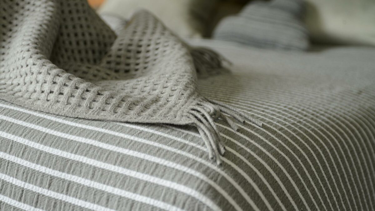 grey stripe bedspread and grey open weave throw